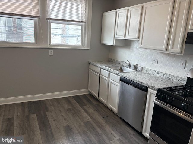 4728 Marple St, Philadelphia, PA 19136 - kitchen with appliances with stainless steel finishes, a sink, baseboards, decorative backsplash, and dark wood-type flooring