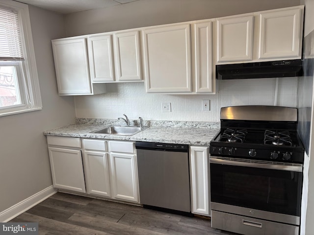 4728 Marple St, Philadelphia, PA 19136 - kitchen featuring appliances with stainless steel finishes, under cabinet range hood, a sink, decorative backsplash, and white cabinets