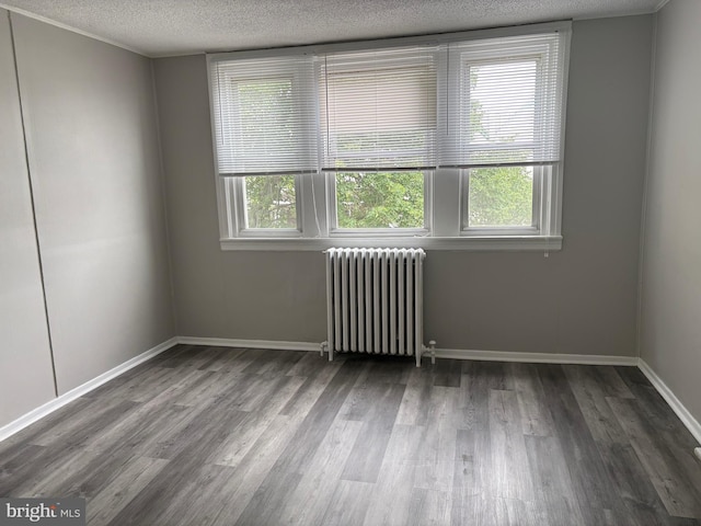 4728 Marple St, Philadelphia, PA 19136 - empty room featuring radiator, a textured ceiling, wood finished floors, and baseboards