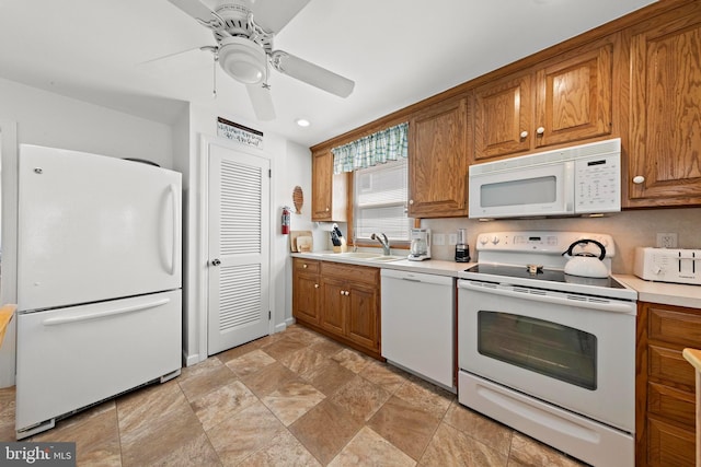 10 E 16th St, Long Beach Township, NJ 08008 - kitchen featuring white appliances, brown cabinets, stone finish flooring, ceiling fan, and recessed lighting