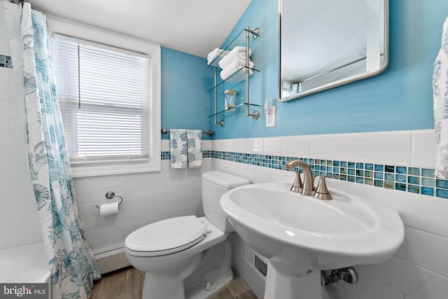 10 E 16th St, Long Beach Township, NJ 08008 - full bath featuring tile walls, toilet, wood finished floors, healthy amount of natural light, and a sink