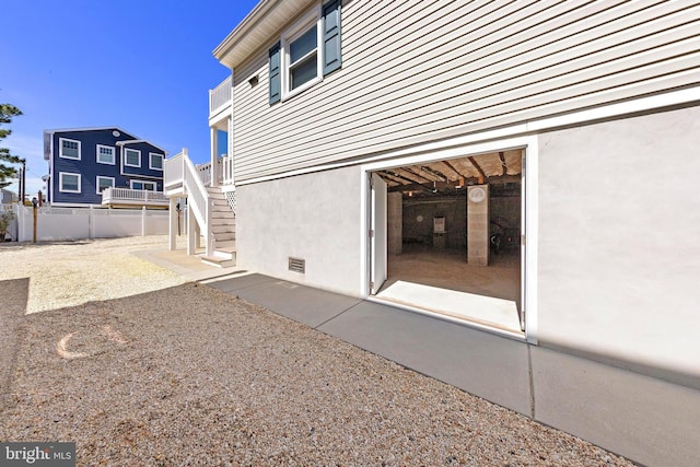 10 E 16th St, Long Beach Township, NJ 08008 - back of house with stairs, stucco siding, and crawl space