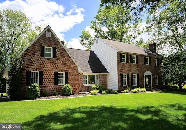 3070 Ursulas Way, Doylestown, PA 18902 - colonial home featuring brick siding, a front lawn, and a chimney