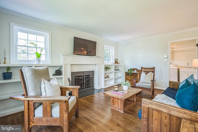 3930 6th St S, Arlington, VA 22204 - living room with washer and clothes dryer, crown molding, wood finished floors, a fireplace, and baseboards