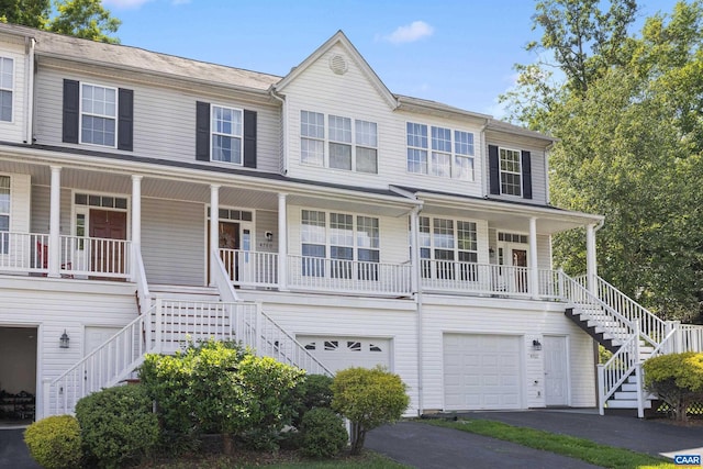 4760 Bluejay Way, Charlottesville, VA 22911 - view of property featuring stairway, covered porch, a garage, and asphalt driveway