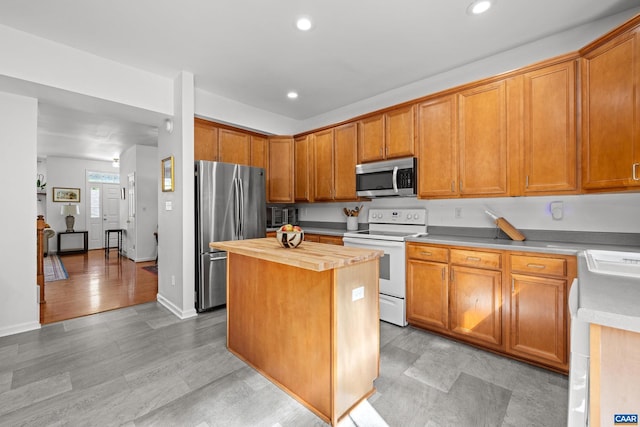 4760 Bluejay Way, Charlottesville, VA 22911 - kitchen with stainless steel appliances, wooden counters, recessed lighting, a kitchen island, and brown cabinetry