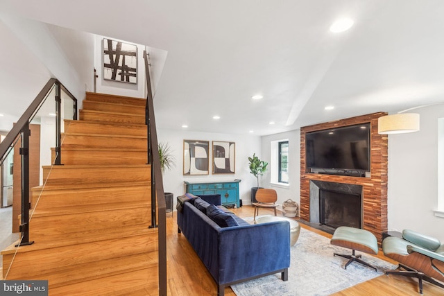 137 Sutton Rd, Ardmore, PA 19003 - living area featuring wood finished floors, a large fireplace, stairs, and recessed lighting