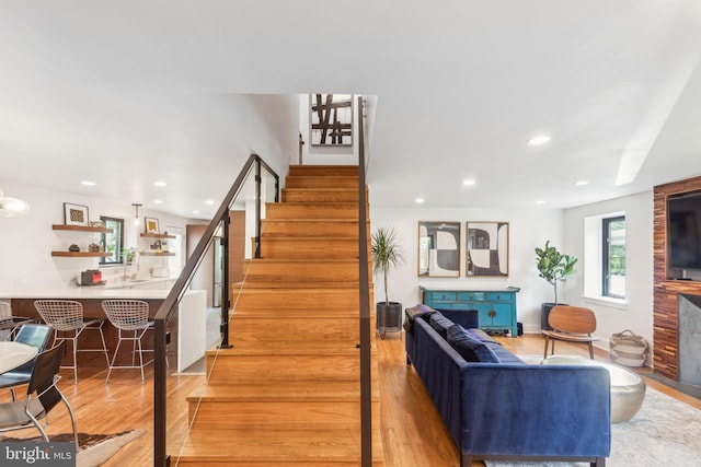 137 Sutton Rd, Ardmore, PA 19003 - stairs with wood finished floors, recessed lighting, and a large fireplace