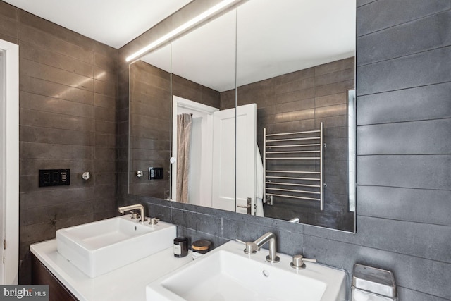137 Sutton Rd, Ardmore, PA 19003 - bathroom with radiator heating unit, a towel warmer, double vanity, and tile walls