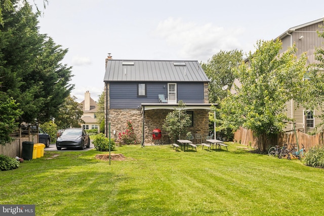 137 Sutton Rd, Ardmore, PA 19003 - back of property with stone siding, a standing seam roof, metal roof, and a chimney