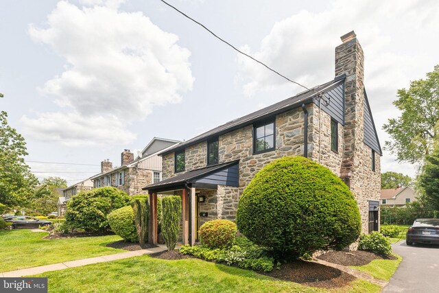 137 Sutton Rd, Ardmore, PA 19003 - view of front of property featuring stone siding, a chimney, and a front yard