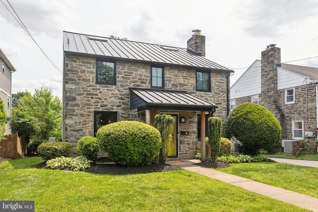 137 Sutton Rd, Ardmore, PA 19003 - view of front of property with a standing seam roof, stone siding, metal roof, and a chimney