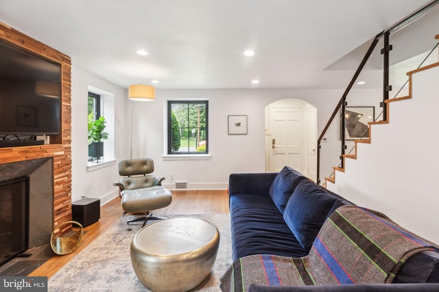 137 Sutton Rd, Ardmore, PA 19003 - living room with stairs, wood finished floors, a fireplace, arched walkways, and recessed lighting