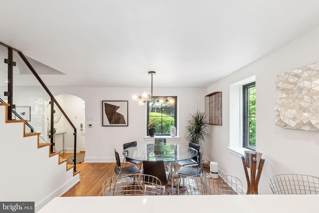 137 Sutton Rd, Ardmore, PA 19003 - dining room featuring stairway, healthy amount of natural light, arched walkways, and wood finished floors