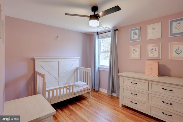 3530 Baker Rd, Westminster, MD 21157 - bedroom featuring a crib, light wood-style flooring, baseboards, and ceiling fan