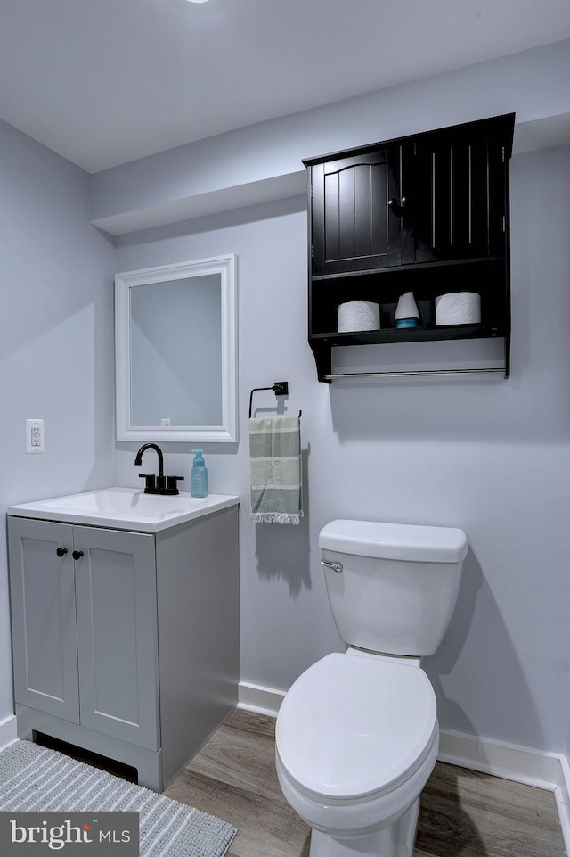 3530 Baker Rd, Westminster, MD 21157 - bathroom featuring vanity, wood finished floors, toilet, and baseboards