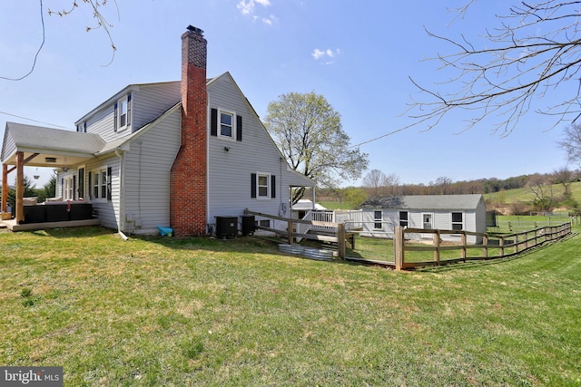 3530 Baker Rd, Westminster, MD 21157 - view of home's exterior with a chimney, central AC unit, an outbuilding, and a deck