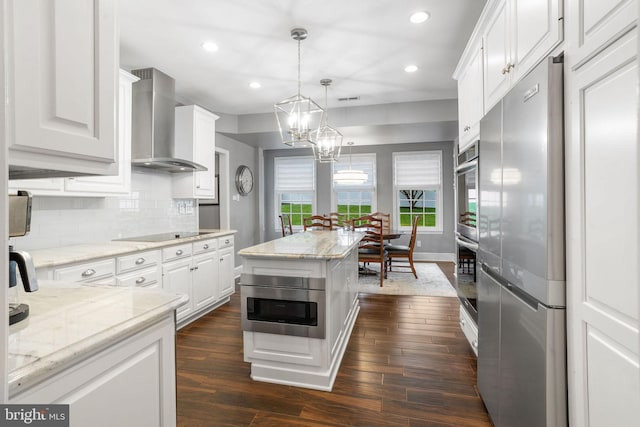 7 Seedling Dr, Holland, PA 18966 - kitchen featuring appliances with stainless steel finishes, wall chimney exhaust hood, white cabinets, recessed lighting, and dark wood finished floors