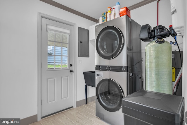 201 Aspen St, Middletown, PA 17057 - laundry area with stacked washing machine and dryer, electric panel, ornamental molding, wood tiled floors, and baseboards