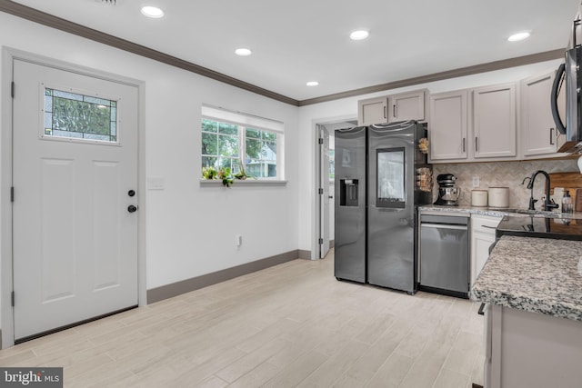 201 Aspen St, Middletown, PA 17057 - kitchen featuring appliances with stainless steel finishes, crown molding, baseboards, a sink, and backsplash