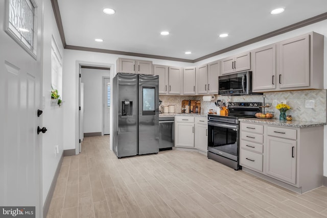 201 Aspen St, Middletown, PA 17057 - kitchen with stainless steel appliances, crown molding, decorative backsplash, baseboards, and light stone countertops