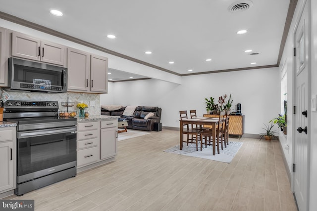 201 Aspen St, Middletown, PA 17057 - kitchen with stainless steel appliances, baseboards, tasteful backsplash, ornamental molding, and light wood-style flooring