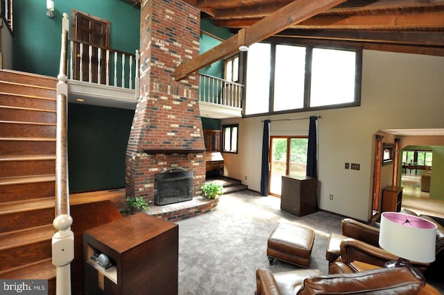 439 Landing St, Lumberton, NJ 08048 - living area featuring high vaulted ceiling, beamed ceiling, stairway, a fireplace, and carpet