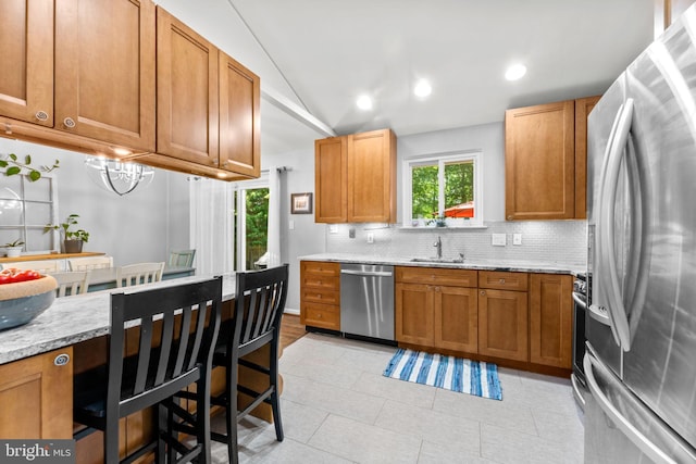 5209 Stonington Dr, Fairfax, VA 22032 - kitchen with stainless steel appliances, decorative backsplash, vaulted ceiling, light stone counters, and a sink