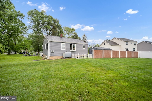 145 Nursery Ave, Levittown, PA 19057 - back of property featuring oil tank and a chimney