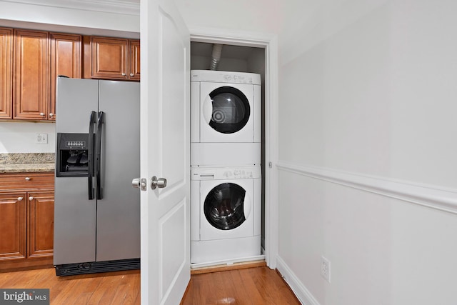 408 Kennedy St NW Unit 202, Washington, DC 20011 - laundry area featuring stacked washer / dryer and light wood-style floors