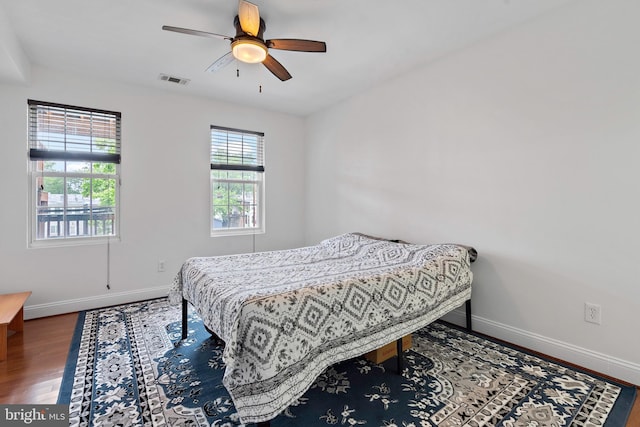 408 Kennedy St NW Unit 202, Washington, DC 20011 - bedroom with baseboards, wood finished floors, and ceiling fan