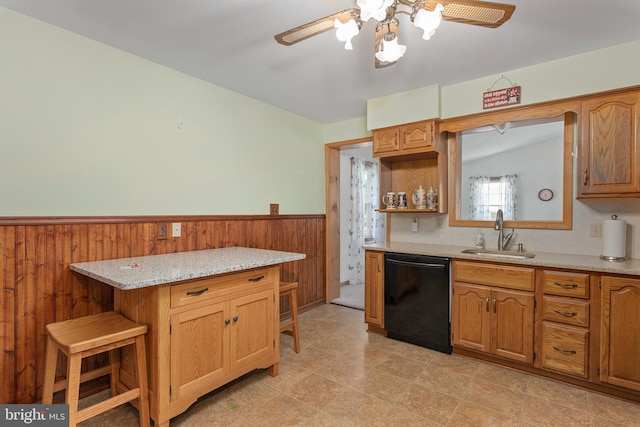 6 Trevett Blvd, Newark, DE 19702 - kitchen with dishwasher, a sink, ceiling fan, a wainscoted wall, and a kitchen bar
