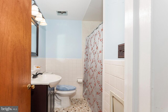 6 Trevett Blvd, Newark, DE 19702 - full bathroom with tile walls, vanity, toilet, wainscoting, and tile patterned floors