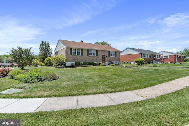 6 Trevett Blvd, Newark, DE 19702 - view of front of home featuring brick siding, a front yard, and a chimney