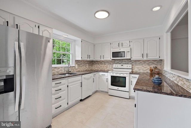 9728 Whetstone Dr, Montgomery Village, MD 20886 - kitchen featuring white appliances, a sink, white cabinets, and decorative backsplash