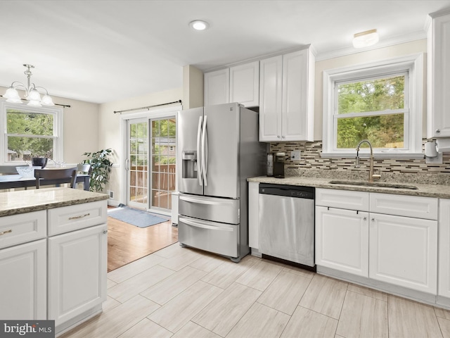 1736 Rhodesia Ave, Fort Washington, MD 20744 - kitchen with appliances with stainless steel finishes, white cabinetry, a chandelier, tasteful backsplash, and light stone counters