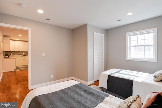 9900 Bird River Rd, Middle River, MD 21220 - bedroom featuring wood finished floors, recessed lighting, a closet, baseboards, and connected bathroom