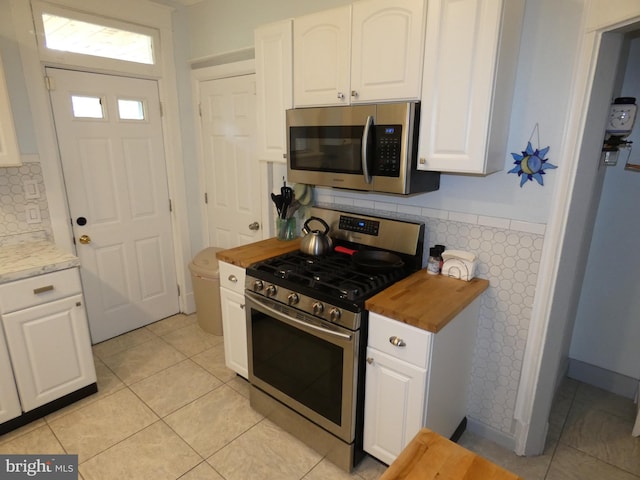 503 Division St, Harrisburg, PA 17110 - kitchen with stainless steel appliances, wood counters, and white cabinetry