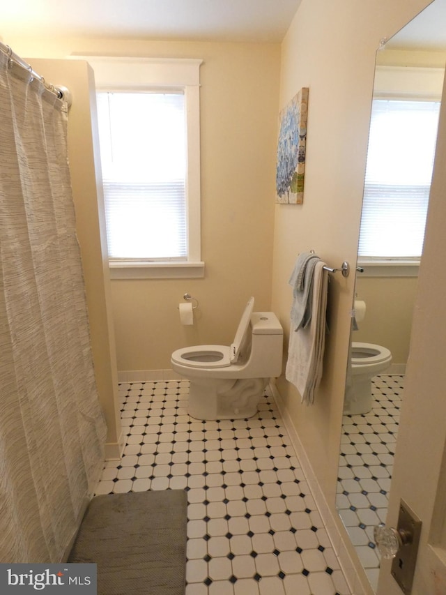 503 Division St, Harrisburg, PA 17110 - bathroom featuring toilet, baseboards, and curtained shower