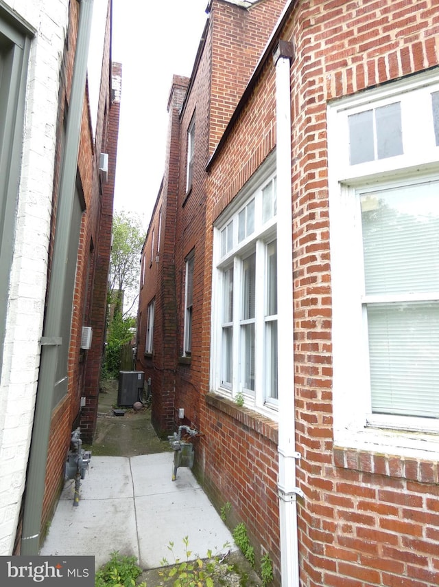 503 Division St, Harrisburg, PA 17110 - view of home's exterior with brick siding, cooling unit, and a patio