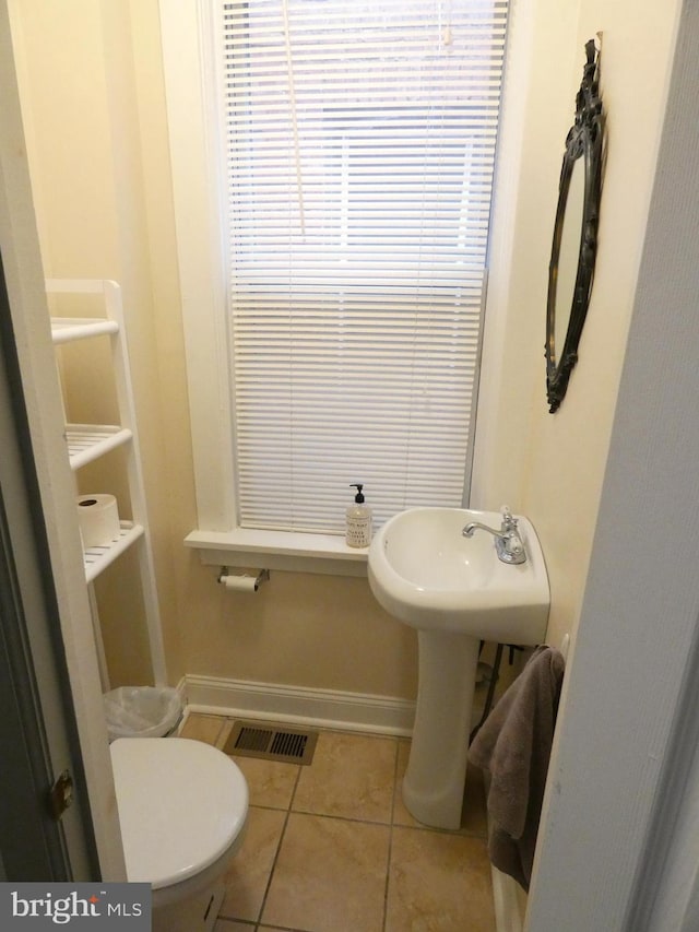 503 Division St, Harrisburg, PA 17110 - bathroom featuring tile patterned floors, baseboards, toilet, and a sink