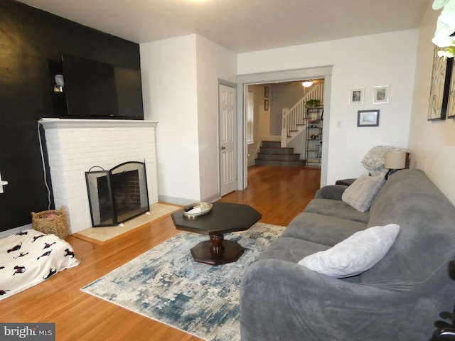 503 Division St, Harrisburg, PA 17110 - living room featuring wood finished floors, stairs, and a fireplace