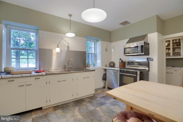 140 Evans Hill Rd, Reading, PA 19608 - kitchen featuring stainless steel appliances, stainless steel counters, white cabinets, pendant lighting, and stone finish floors