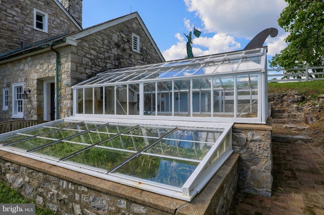 140 Evans Hill Rd, Reading, PA 19608 - view of property exterior featuring stone siding, a greenhouse, and an outbuilding