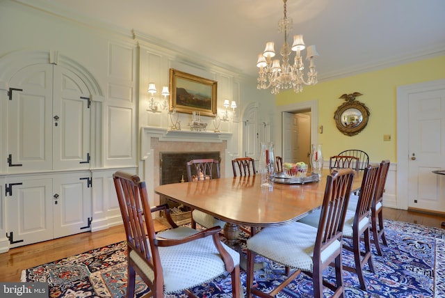 140 Evans Hill Rd, Reading, PA 19608 - dining room with light wood finished floors, a chandelier, a premium fireplace, and ornamental molding