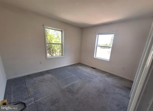 226 Bethel Rd, Somers Point, NJ 08244 - spare room featuring healthy amount of natural light, baseboards, and dark carpet