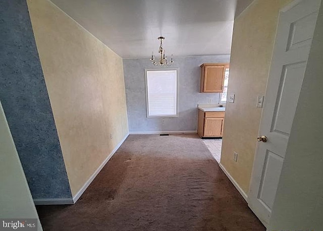 226 Bethel Rd, Somers Point, NJ 08244 - corridor with a chandelier, baseboards, light carpet, and a sink