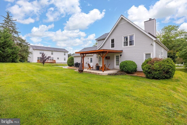 9 Tally Ho Dr, Fredericksburg, VA 22405 - rear view of house with a chimney, a lawn, and a patio area