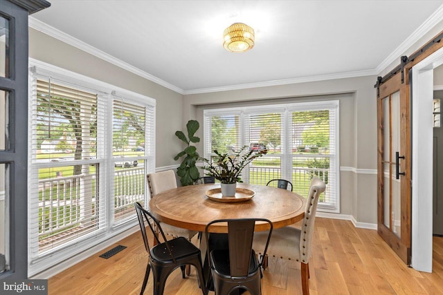 9 Tally Ho Dr, Fredericksburg, VA 22405 - dining room with a barn door, crown molding, light wood-type flooring, and baseboards