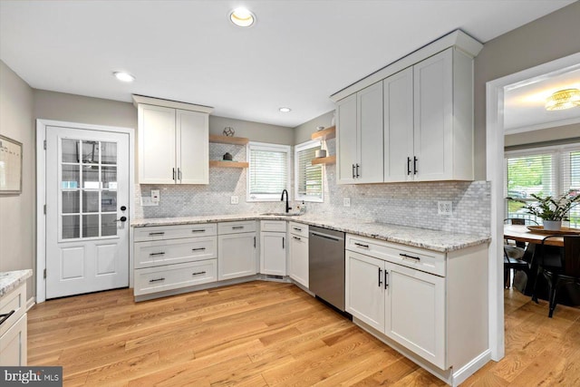 9 Tally Ho Dr, Fredericksburg, VA 22405 - kitchen with stainless steel dishwasher, a sink, open shelves, decorative backsplash, and light wood-style flooring